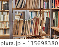 Many book shelves in a library 135698380