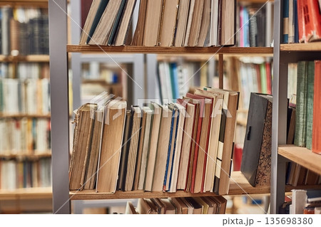 Many book shelves in a library 135698380