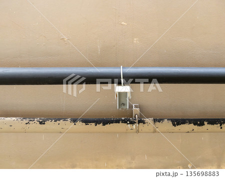 Industrial HVAC pipes with rubber insulation on building walls. Industrial HVAC pipes with rubber insulation on building walls. 135698883
