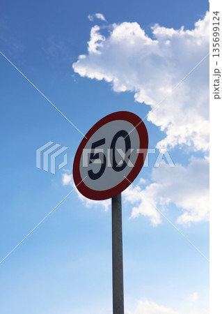 Road Speed Limit Sign Against Sky 135699124