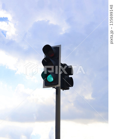 Green Traffic Signal Against Cloudy Sky 135699148
