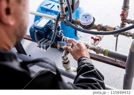 Technician checking water system nodes.Modern Industrial background 135699432