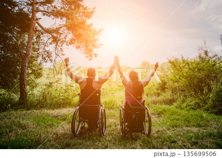 Handicapped couple resting in the forest near lake. Handicapped couple resting in the forest near lake. 135699506