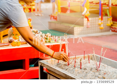 Symbols of Buddhism. Burning incense sticks. South-Eastern Asia. Symbols of Buddhism. Burning incense sticks. South-Eastern Asia. 135699529