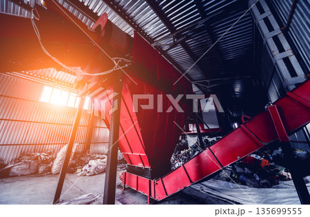 At modern recycling plant. Conveyor belt for transports garbage At modern recycling plant. Conveyor belt for transports garbage 135699555