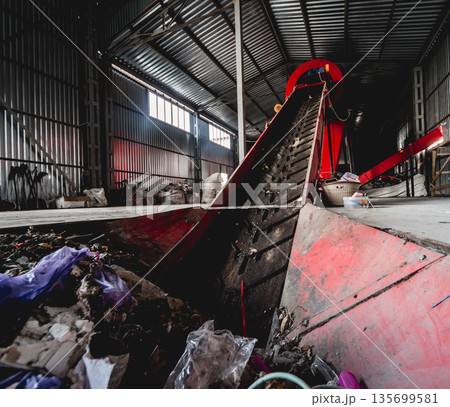 At modern recycling plant. Conveyor belt for transports garbage At modern recycling plant. Conveyor belt for transports garbage 135699581
