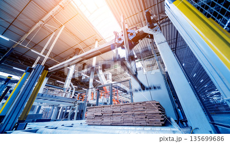 Production line of the wooden floor factory. CNC automatic woodworking machine. 135699686