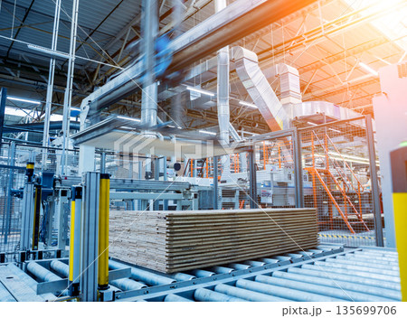 Production line of the wooden floor factory. CNC automatic woodworking machine. Production line of the wooden floor factory. CNC automatic woodworking machine. 135699706