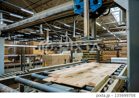 Production line of the wooden floor factory. CNC automatic woodworking machine. Production line of the wooden floor factory. CNC automatic woodworking machine. 135699708