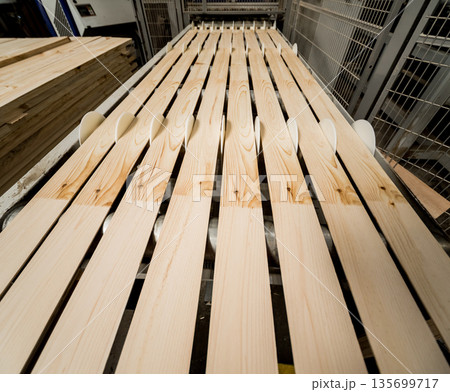 Production line of the wooden floor factory. CNC automatic woodworking machine. Production line of the wooden floor factory. CNC automatic woodworking machine. 135699717