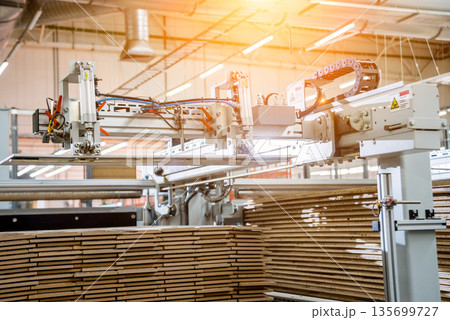 Production line of the wooden floor factory. CNC automatic woodworking machine. Production line of the wooden floor factory. CNC automatic woodworking machine. 135699727