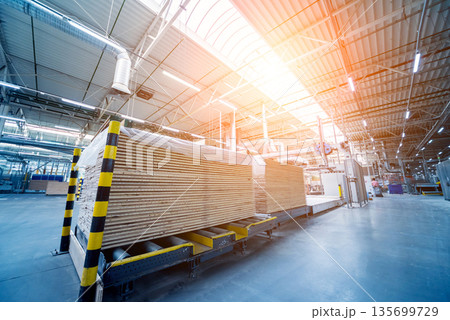 Production line of the wooden floor factory. CNC automatic woodworking machine. 135699729