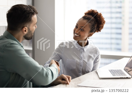 African businesswoman greeting company client met in office African businesswoman greeting company client met in office 135700222
