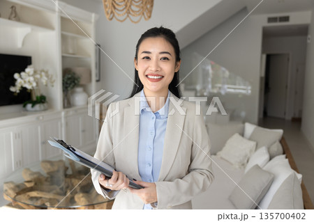 Portrait of smiling young Vietnamese realtor woman Portrait of smiling young Vietnamese realtor woman 135700402