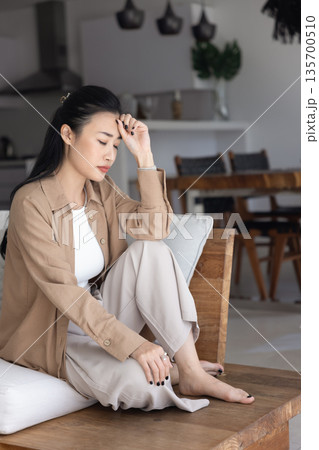 Asian woman thinks on conflict or break up at home 135700510