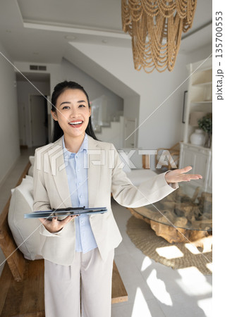 Young realtor woman showcasing apartment features to customers Young realtor woman showcasing apartment features to customers 135700553