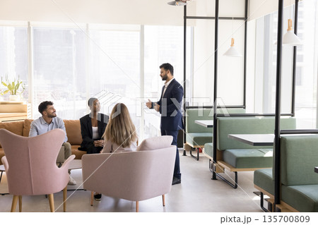 Male business coach speak before multicultural team on casual training 135700809
