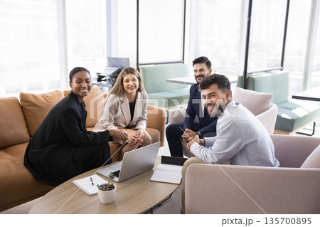 Happy multiethnic businesspeople team working in creative space looking aside Happy multiethnic businesspeople team working in creative space looking aside 135700895