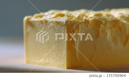 Close-up of Premium Butter Block with Matte Texture and Gentle Side Lighting 135700904