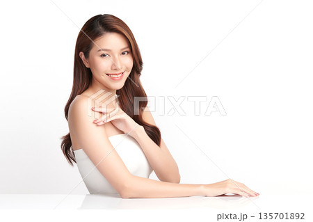 A beautiful young Asian woman with clean, fresh skin against a white background. Skincare, facial treatment, cosmetology, beauty, and spa. An elegant portrait of an Asian woman. A beautiful young Asian woman with clean, fresh skin against a white background. Skincare, facial treatment, cosmetology, beauty, and spa. An elegant portrait of an Asian woman. 135701892