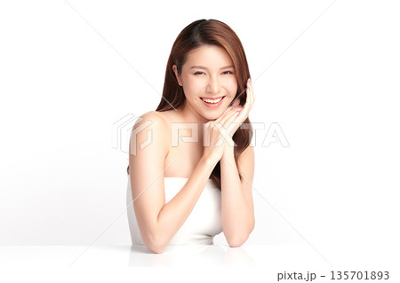A beautiful young Asian woman with clean, fresh skin against a white background. Skincare, facial treatment, cosmetology, beauty, and spa. An elegant portrait of an Asian woman. A beautiful young Asian woman with clean, fresh skin against a white background. Skincare, facial treatment, cosmetology, beauty, and spa. An elegant portrait of an Asian woman. 135701893