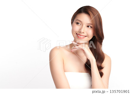 A beautiful young Asian woman with clean, fresh skin against a white background. Skincare, facial treatment, cosmetology, beauty, and spa. An elegant portrait of an Asian woman. 135701901