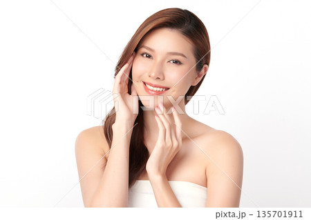 A beautiful young Asian woman with clean, fresh skin against a white background. Skincare, facial treatment, cosmetology, beauty, and spa. An elegant portrait of an Asian woman. 135701911