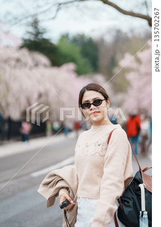 Woman tourist sightseeing Sakura Cherry Blossom in Spring. Happy traveler travel in Samurai village or Little Kyoto in Kakunodate town, Semboku District, Akita Prefecture, Japan. Landmark and Vacation Woman tourist sightseeing Sakura Cherry Blossom in Spring. Happy traveler travel in Samurai village or Little Kyoto in Kakunodate town, Semboku District, Akita Prefecture, Japan. Landmark and Vacation 135702267