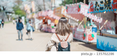 Woman tourist sightseeing Morioka Sakura Festival at Morioka Castle Ruins during Cherry Blossom in Spring, happy traveler travel in Iwate Park, Iwate prefecture, Japan. famous Landmark Travel 135702286