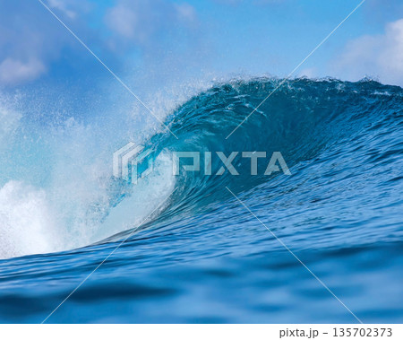 Vast Ocean Wave Crashing Fiercely, Powerful Surf Surging Beneath Bright Sky 135702373