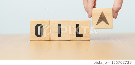 Hand change wooden block with OIL text to UP and Down arrow symbol icon. Trade war, stocks, financial, cut loss and economic concept 135702729