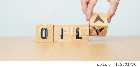 Hand change wooden block with OIL text to UP and Down arrow symbol icon. Trade war, stocks, financial, cut loss and economic concept 135702730
