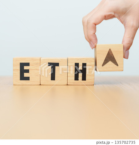 Hand change Wooden block with ETH or Ethereum text to UP and Down arrow symbol. cryptocurrency, blockchain, price, down and up, decrease and increase, cut loss, trade and financial concepts 135702735