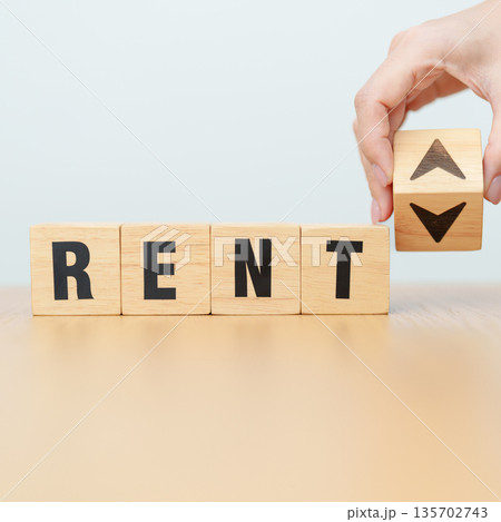 hand change wooden block with RENT text to UP and Down arrow. Price decrease and Increase, real estate, home, car, Financial, money Value, discount, investment and economic recession concept 135702743