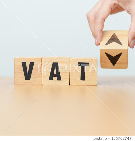 hand change wooden block with VAT text to UP and Down arrow icon. Value Added Tax, decrease and Increase, Taxpayer, Taxable Income, Tax Filing, Deduction, Withholding Tax,  Computation and Exemption 135702747