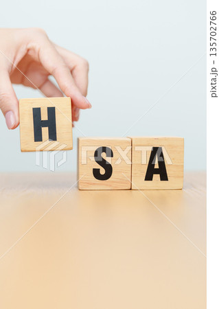 hand change wooden block from FSA. HSA, Flexible Spending Account and Health Savings Account, Medical Expenses, Tax Benefits and healthcare concepts hand change wooden block from FSA. HSA, Flexible Spending Account and Health Savings Account, Medical Expenses, Tax Benefits and healthcare concepts 135702766