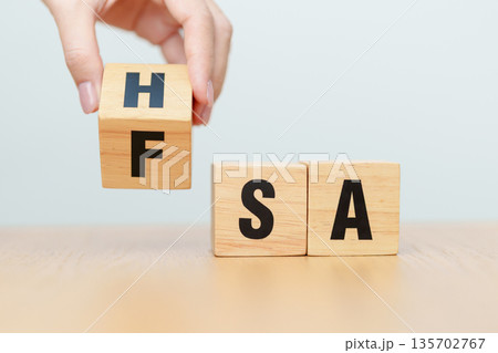 hand change wooden block from FSA to HSA. Flexible Spending Account and Health Savings Account, Medical Expenses, Tax Benefits and healthcare concepts hand change wooden block from FSA to HSA. Flexible Spending Account and Health Savings Account, Medical Expenses, Tax Benefits and healthcare concepts 135702767