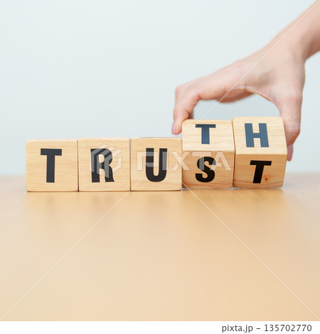 hand change wooden block TRUST to TRUTH. Trustworthy, Truth, beliefs business and agreement concept 135702770