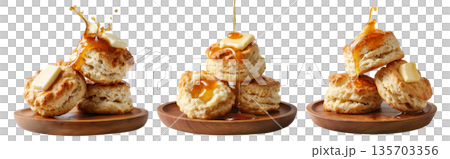 Buttermilk biscuits topped with syrup and butter, stacked on a wooden plate, isolated on white background, concept of breakfast 135703356