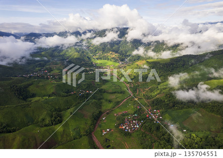 Landscape of Morning Mist with Mountain Layer. mountain ridge and clouds in rural jungle bush forest Landscape of Morning Mist with Mountain Layer. mountain ridge and clouds in rural jungle bush forest 135704551