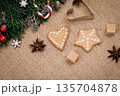 Christmas gingerbread cookies and festive decorations on burlap background, flat-lay 135704878