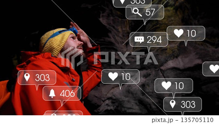 Gazing mid-adult explorer adjusting headlamp in dark cave, with floating social icons, copy space Gazing mid-adult explorer adjusting headlamp in dark cave, with floating social icons, copy space 135705110