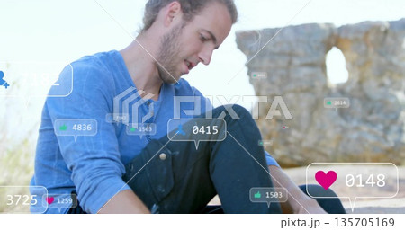 Leaning man studying notification overlays on rocky outcrop by stone arch, with floating icons 135705169