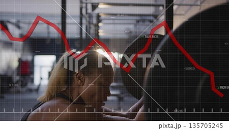 Bracing woman in sports top gripping loaded barbell under rack in gym, with grid graph overlay 135705245