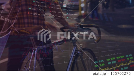 Walking mid-adult man pushing fixed-gear bicycle on wet street at night with stock chart overlays Walking mid-adult man pushing fixed-gear bicycle on wet street at night with stock chart overlays 135705276