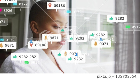 Staring downward woman in white bathrobe beside large window, displaying notification bubbles Staring downward woman in white bathrobe beside large window, displaying notification bubbles 135705354