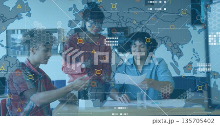 Collaborating tech professionals examining prototype, reviewing docs in office with overlay 135705402