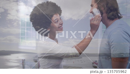 Couple applying shaving foam at bathroom counter with faucet mirror frame glass window harbor view Couple applying shaving foam at bathroom counter with faucet mirror frame glass window harbor view 135705962
