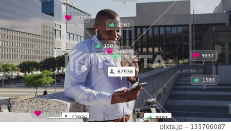 Checking social media alerts, man wearing shirt holding phone, coffee cup on terrace with bicycle Checking social media alerts, man wearing shirt holding phone, coffee cup on terrace with bicycle 135706087