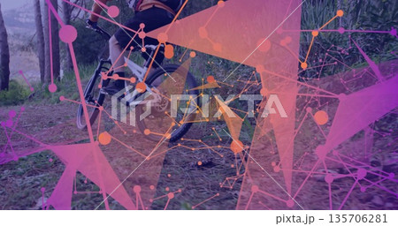 Male cyclist wearing helmet and jersey pedaling mountain bike on dirt trail, with network shapes Male cyclist wearing helmet and jersey pedaling mountain bike on dirt trail, with network shapes 135706281